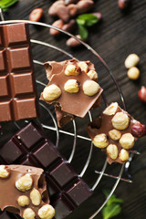 Set of chocolate with nuts on metal stand, top view