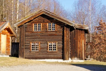 Zelfklevend Fotobehang Norwegian building of round logs with small shutters © mariuszks