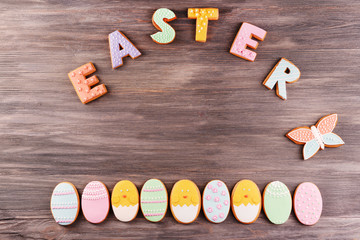 Delicious Easter cookies on wooden background