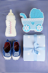 Baby shoes with baby equipment on blue background