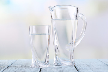 Glass pitcher and glass of water