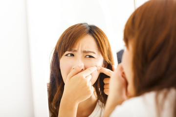 Young  woman with pimple on her face