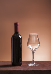 Red wine bottle and empty wineglass