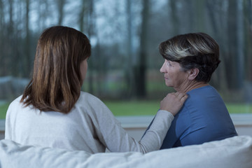 Granddaughter supporting worried grandma