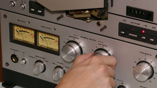 hand man operates reel tape recorder - 4k