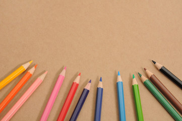 Coloured pencil on the bottom of brown background