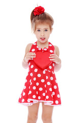Charming girl in a red dress with white polka