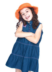 Smiling girl in a denim dress and orange hat