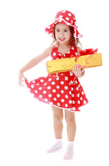 Girl in summer red polka dot dress holding a gift