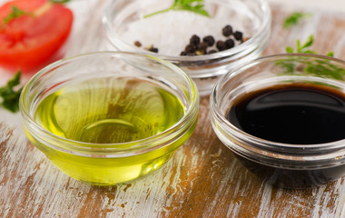 Bowl of Balsamic vinegar, salt and olive oil on a wooden table