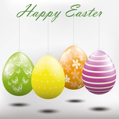 Easter eggs hanging from a string.