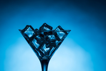 Close up of martini glass filled with ice cubes