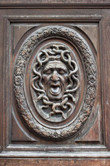 Medusa head carving on a door