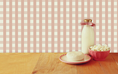 greek cheese , bulgarian cheese and milk on wooden table over ru