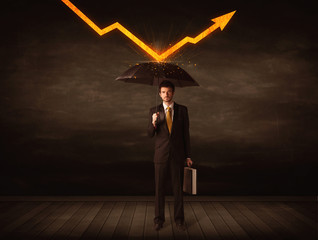 Businessman standing with umbrella keeping orange arrow