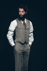 Relaxed bearded businessman looking back