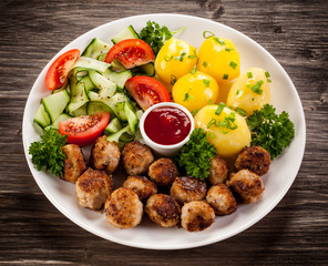 Roast meatballs, French fries and vegetable salad