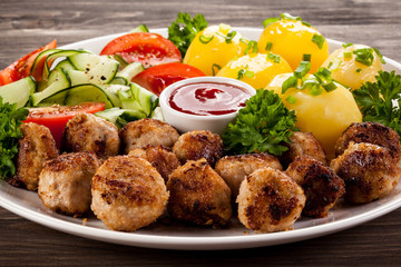 Roast meatballs, French fries and vegetable salad