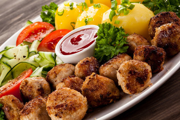 Roast meatballs, French fries and vegetable salad