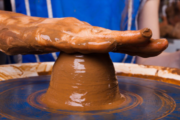 hand of artisan on pottery wheel