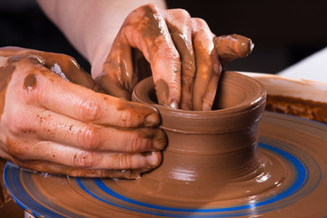 hands making clay pot
