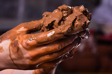 hands of a potter with clay