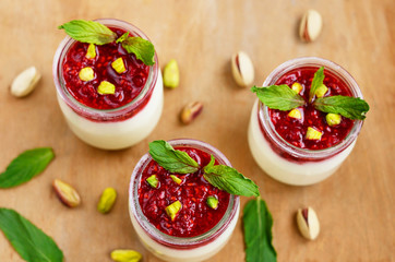 Homemade yogurt with fresh raspberry jam and pistachio
