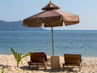 Beach chair and umbrella on the beach in sunny day , Thailand