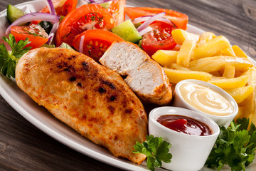 Fried chicken fillet, chips and vegetable salad