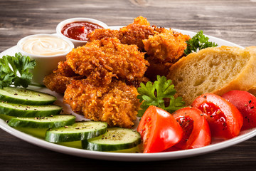 Fried chicken nuggets and vegetables