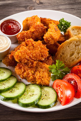 Fried chicken nuggets and vegetables
