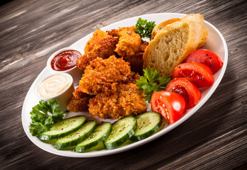 Fried chicken nuggets and vegetables