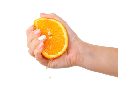Female Hand Squeezing Orange Isolated On White