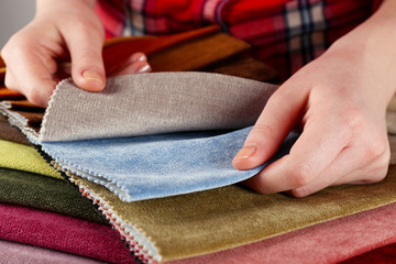 Woman chooses scraps of colored tissue on table close up
