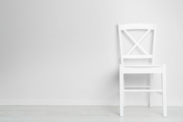 Modern chair on white wall background