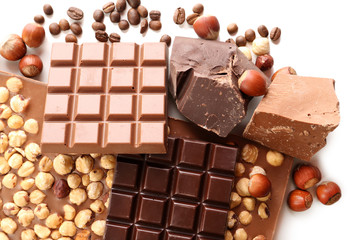 Chocolate bars with hazelnuts and coffee beans close up