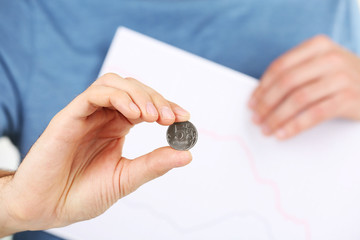 Man holding coin close up