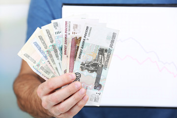 Man holding money and graph document close up