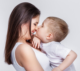 happy mother with a child on light grey background