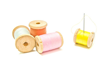 four spools of thread with needle