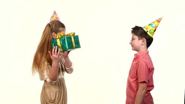Little boy gives a girl  box with gift green birthday. white