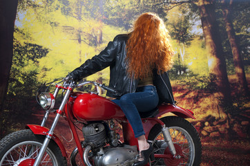 Fototapeta na wymiar Redhead girl on motorbike