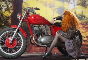 Naklejka na ściany i meble Redhead girl on motorbike