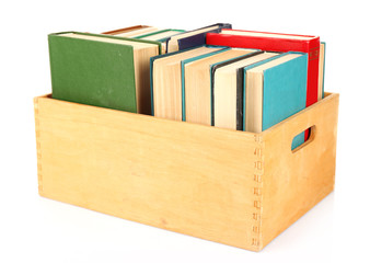 Books in wooden box isolated on white