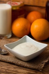 Square bowl with white yogurt on jute cloth