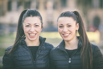 Female twins portrait at park