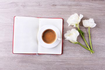 Obraz na płótnie Canvas Beautiful tulips with diary and cup of coffee