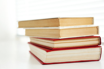 Books on white windowsill, close up