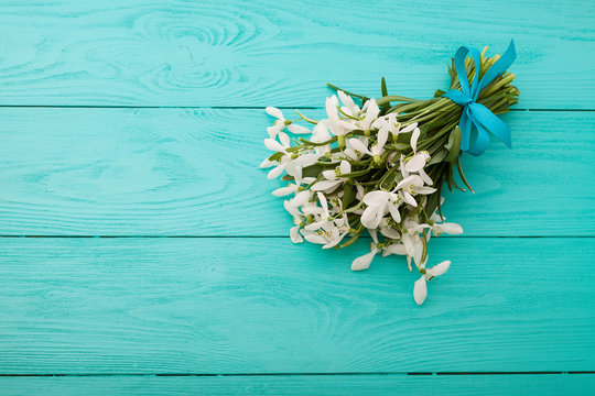 Bouquet of flowers on blue wooden background