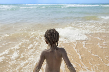 Afro girl at the beach, six years old